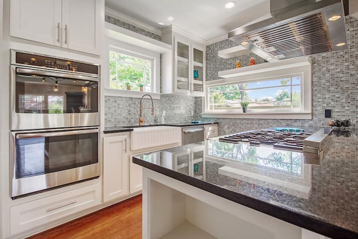 An image of a modern kitchen with sleek appliances, featuring a gas stove, refrigerator, and built-in microwave in Chester County